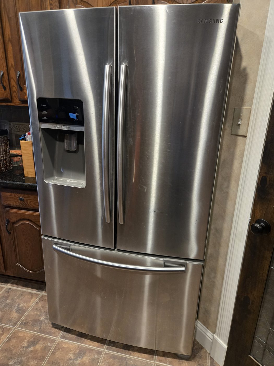 A stainless French-door refrigerator in a customer kitchen