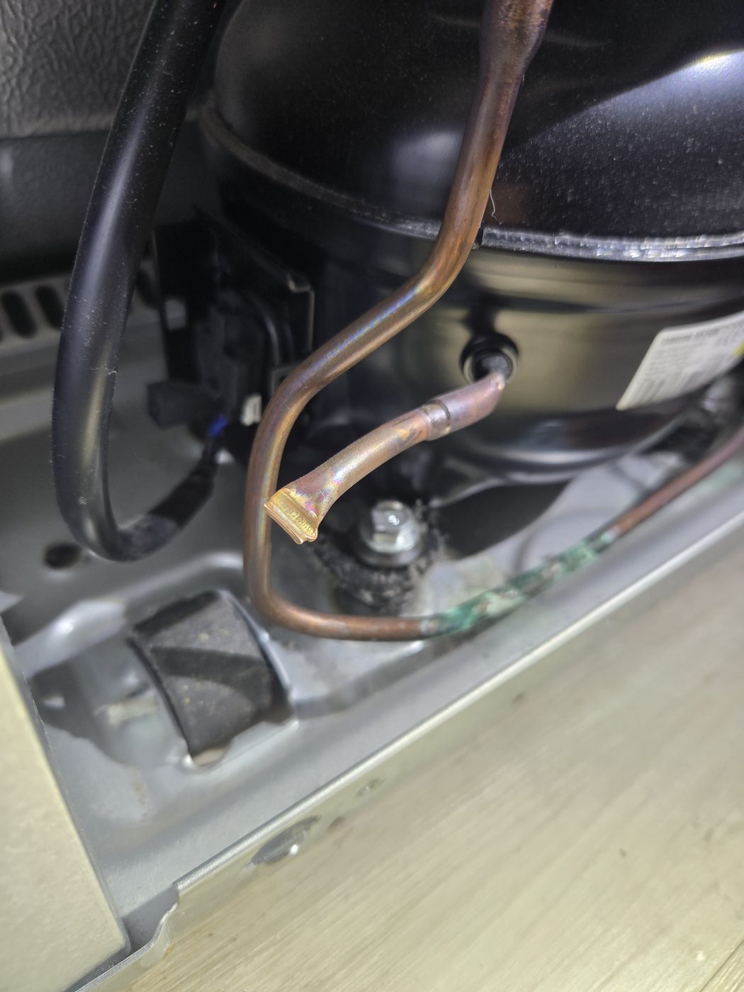 Refrigerator compressor and condenser at the base of the unit