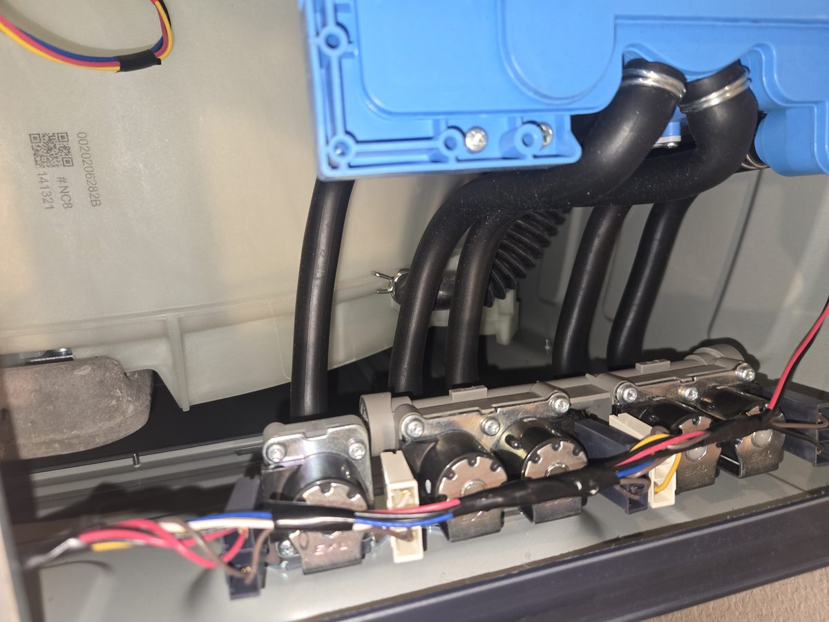 Appliance control board opened up showing the wiring harness, relays and connectors during diagnosis