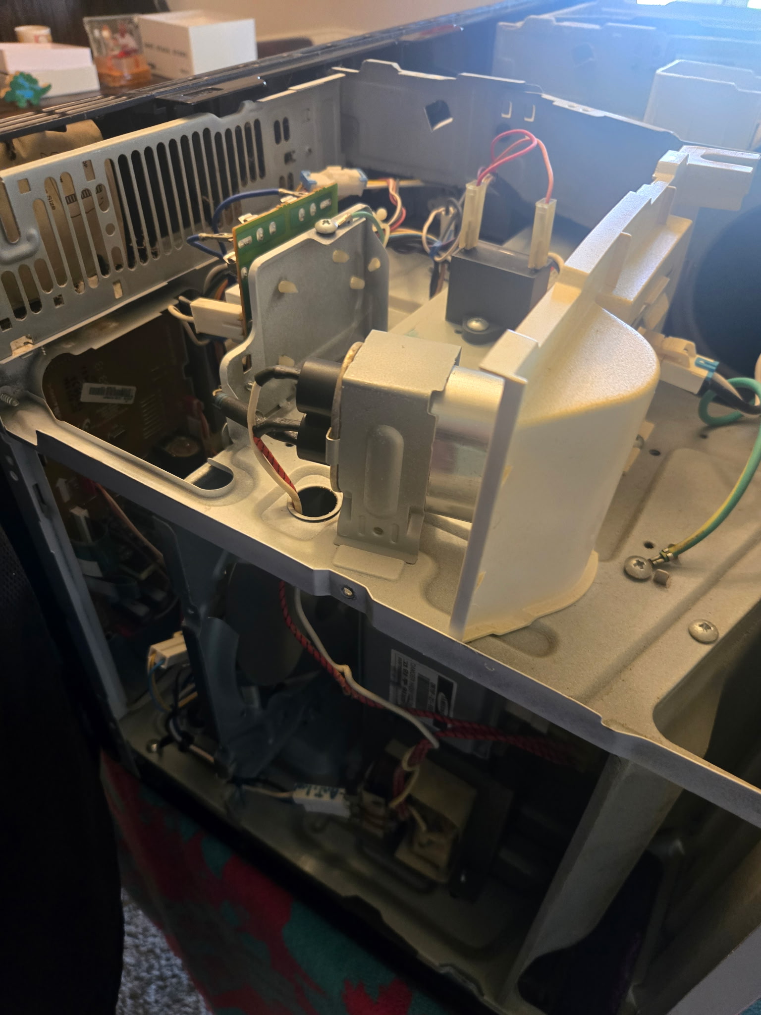 Microwave with cover removed showing the transformer and internal components